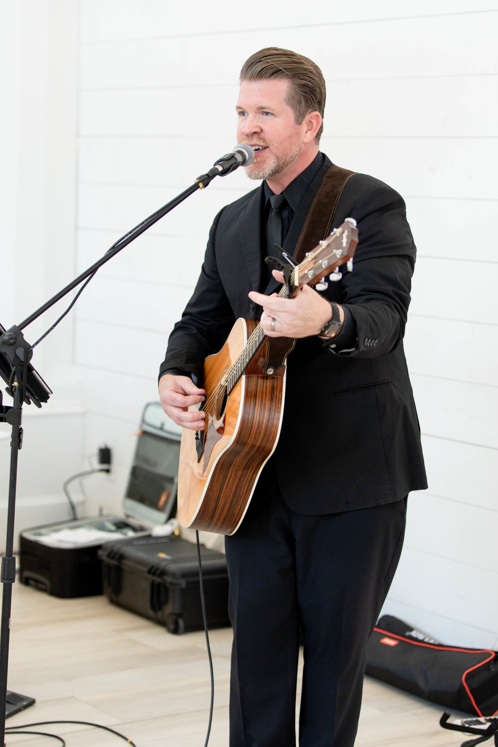 Man with a guitar performs live at a wedding reception